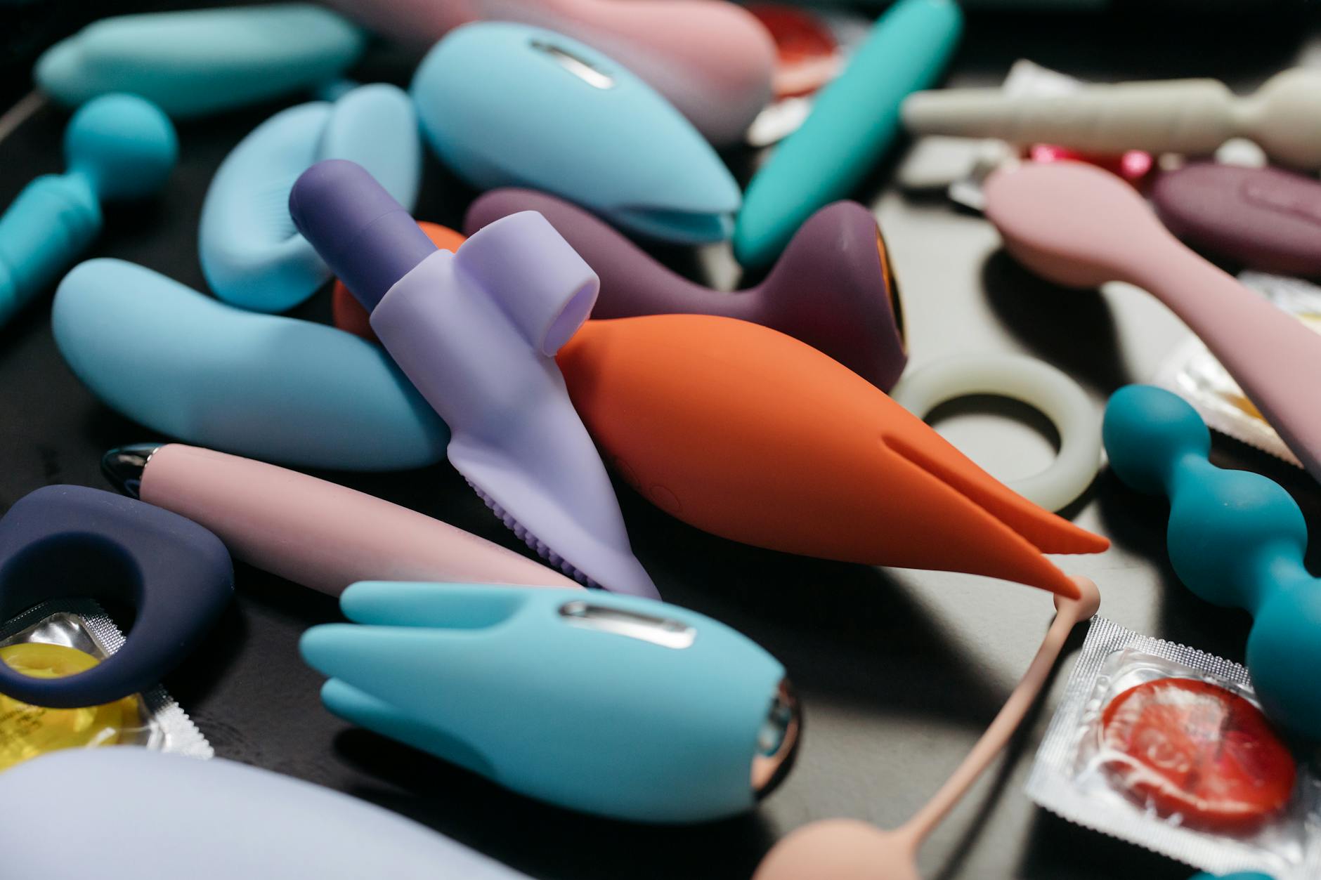 An array of vibrant clitoral vibrators and adult toys in close-up view